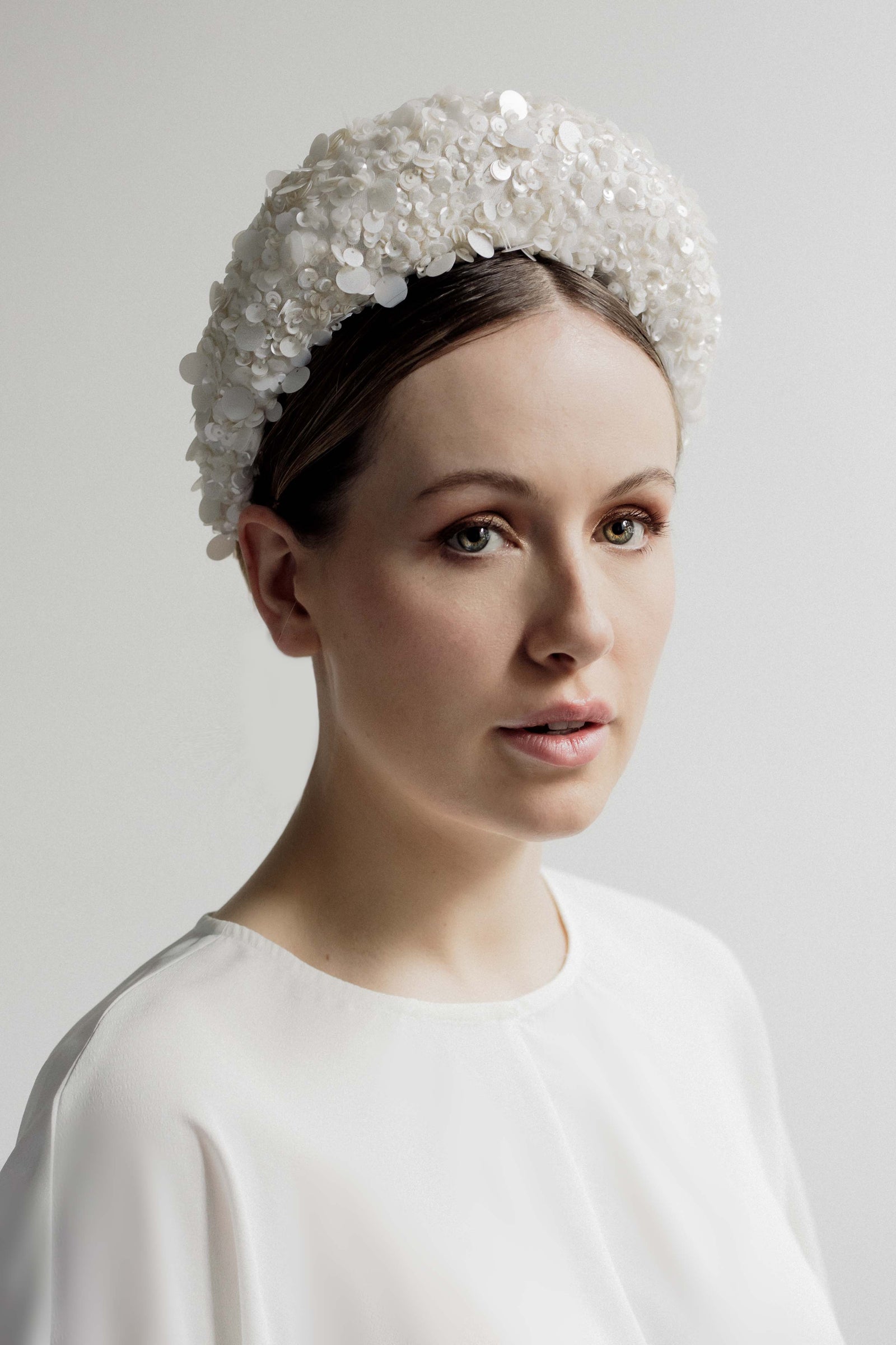 Amara is a luxurious sequin halo headband.  This elegant sequinned halo is perfect for pairing with an elegant, clean lined wedding outfit   The halo attaches with hair combs. One Size.